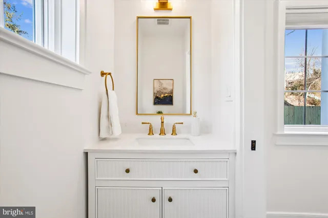 a living room with lots of furniture and kitchen view