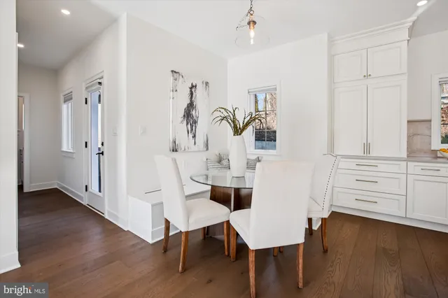 a living room with a dining table furniture and a kitchen view