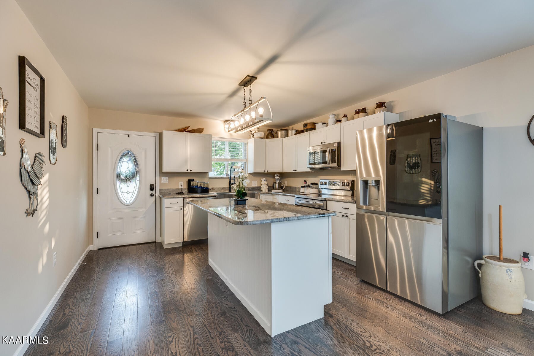117 Cherokee Cove Rutledge, TN 37861 - Photo 8 of 43 a kitchen with stainless steel appliances a refrigerator a sink dishwasher a stove and white cabinets with wooden floor