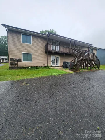 a view of a house with a yard and garage