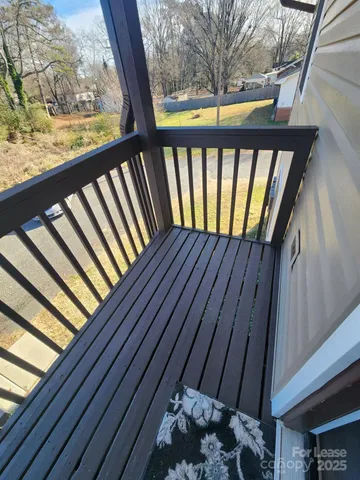 a view of balcony with wooden floor
