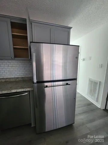 a refrigerator freezer sitting inside of a kitchen