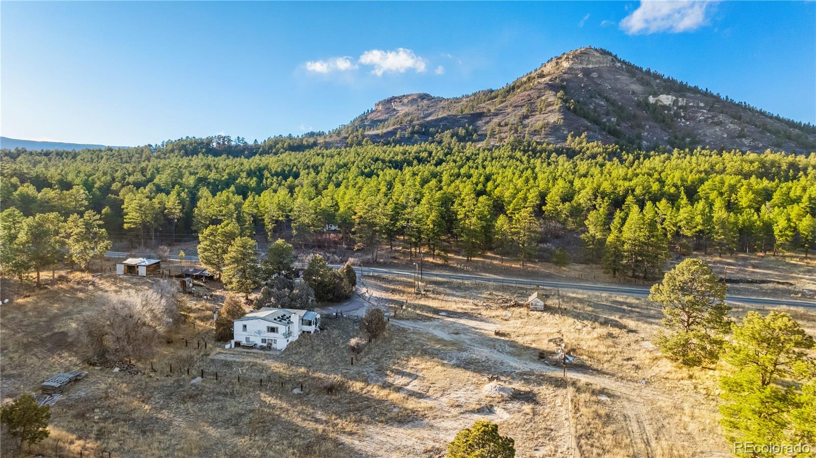 436 West Fox Farm Road Larkspur, CO 80118 - Photo 35 of 50 a view of a house with a yard