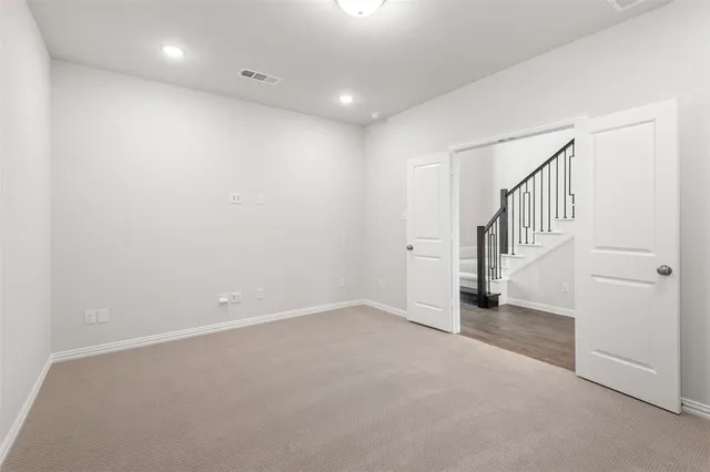 a view of an empty room with stairs