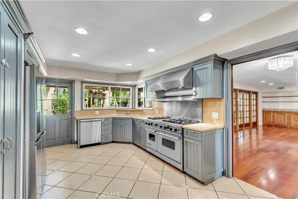 a kitchen with a stove top oven sink and cabinets