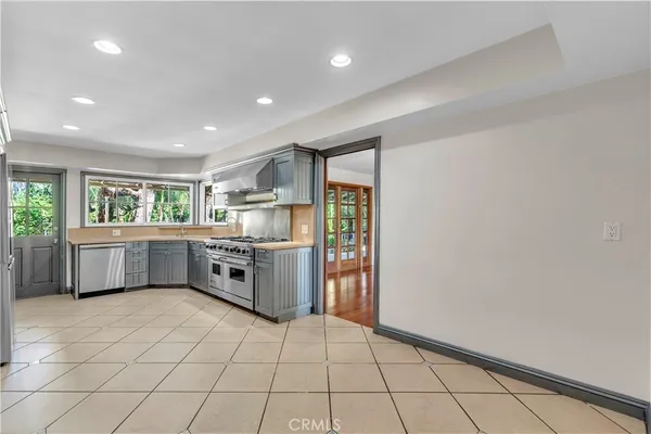 a kitchen with stainless steel appliances a refrigerator sink and cabinets