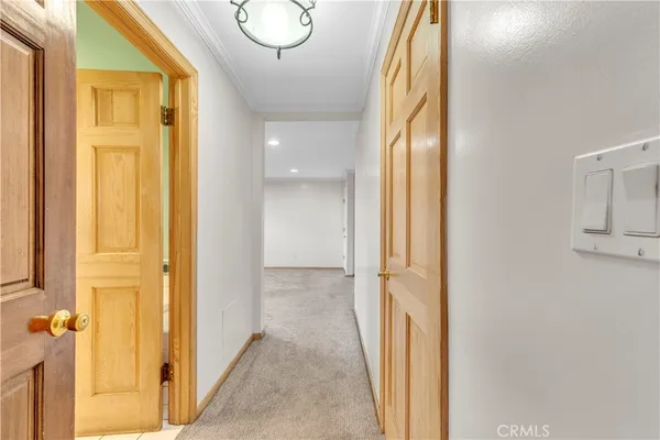 a view of an empty room with glass door and windows