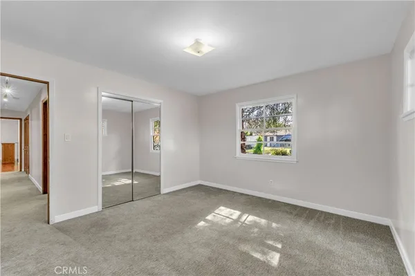 a view of a porch with furniture and a backyard
