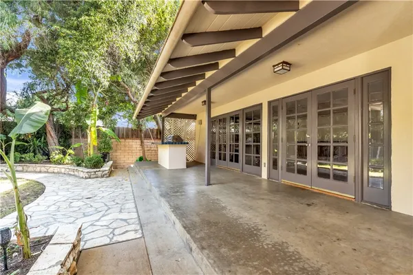 a view of a house with a yard and tree s