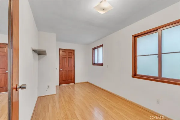 a yellow house with trees in front of it