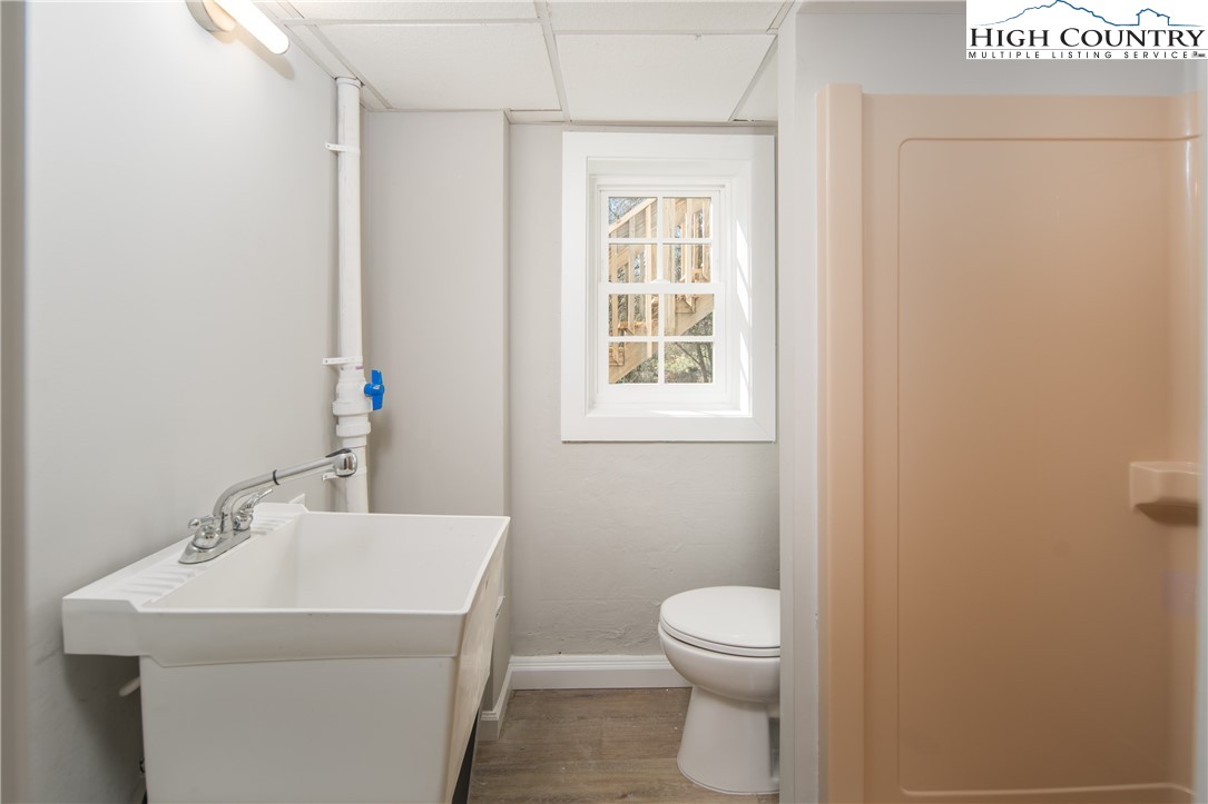 553 Hardaman Circle Boone, NC 28607 - Photo 27 of 42 a bathroom with a sink a toilet and a window