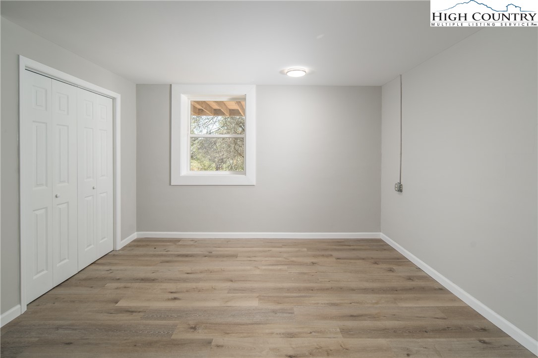 553 Hardaman Circle Boone, NC 28607 - Photo 29 of 42 a view of an empty room with wooden floor and a window