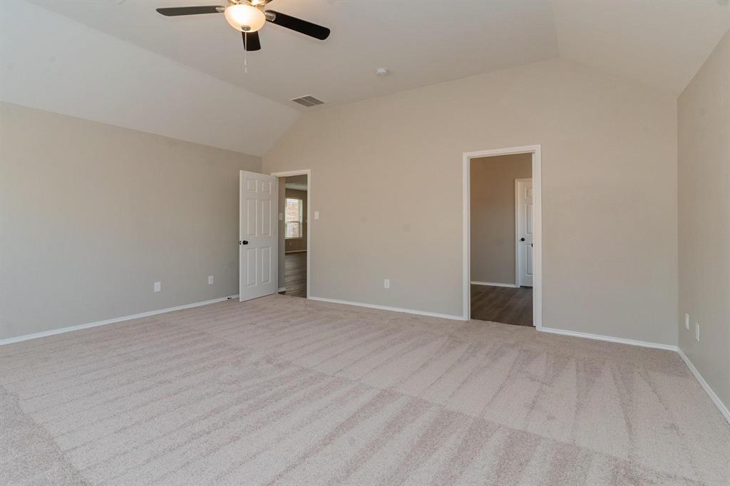 4313 Summer Star Lane Fort Worth, TX 76244 - Photo 15 of 26 Unfurnished bedroom with vaulted ceiling, carpet flooring, and a ceiling fan