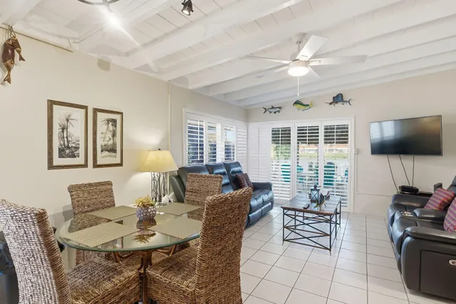 a living room with furniture a flat screen tv and wooden floor