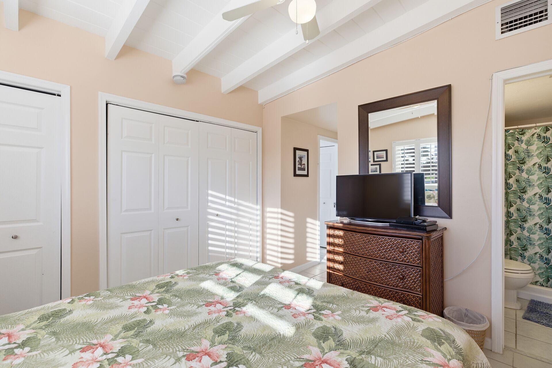 26 7th Street Key Colony Beach, FL 33051 - Photo 16 of 37 a bedroom with a bed and a flat screen tv
