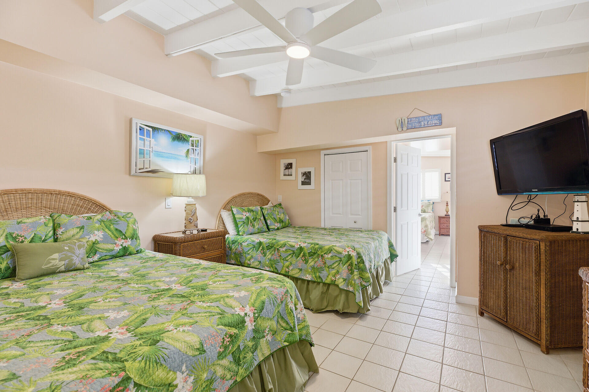 26 7th Street Key Colony Beach, FL 33051 - Photo 19 of 37 a bedroom with two beds and a flat screen tv