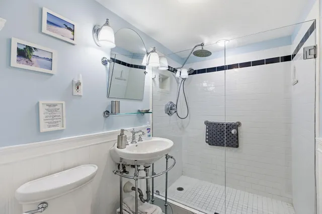 a bathroom with a sink toilet and shower