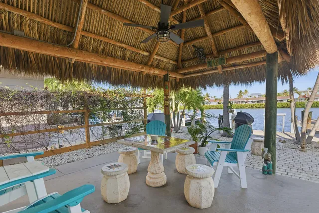 a view of a patio with table and chairs potted plants