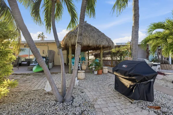 a view of a backyard with a table and chairs under an umbrella