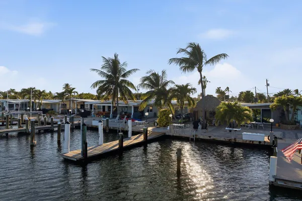 a view of water with boats and trees in the background