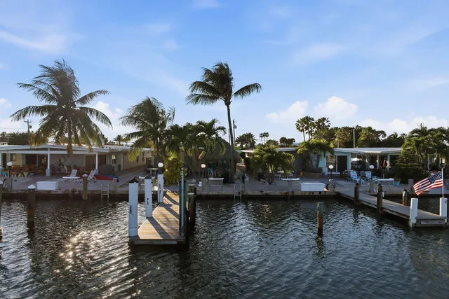 a view of house with swimming pool and outdoor seating
