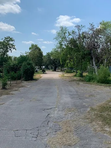 a view of an ocean with trees in the background
