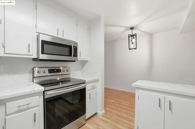 a kitchen with a refrigerator stove and microwave