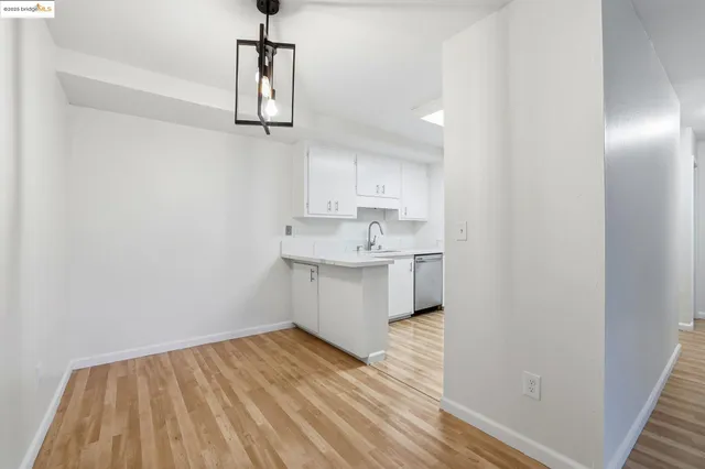 a kitchen with stainless steel appliances granite countertop a sink and microwave with wooden floor