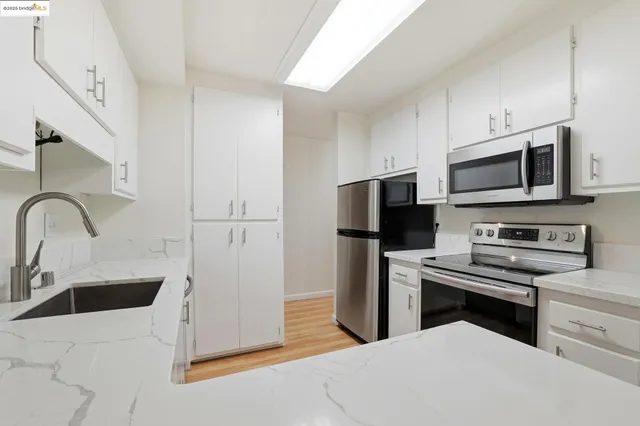 a kitchen with a sink stove and refrigerator