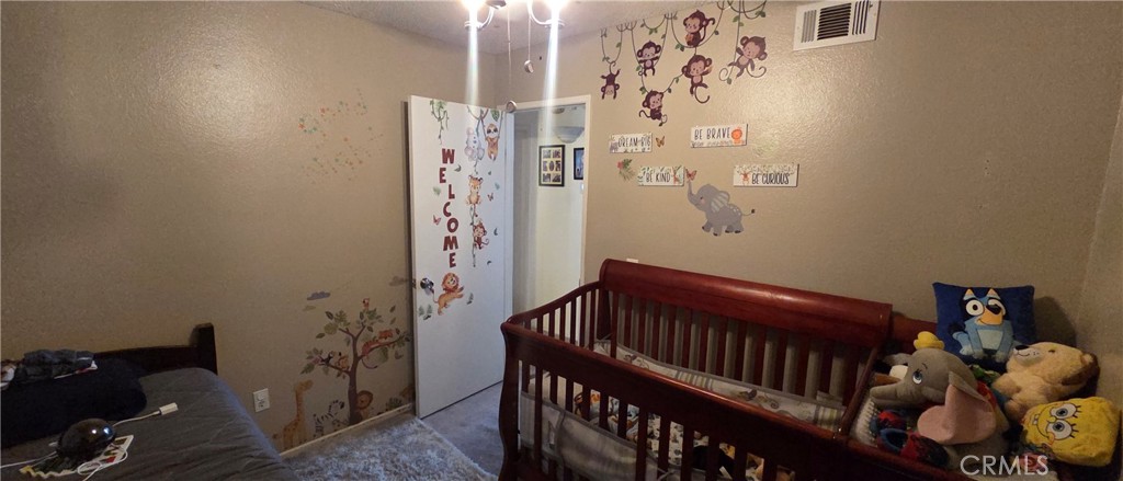 1548 Ranch Road San Bernardino, CA 92407 - Photo 15 of 26 a bedroom with a bed and wooden floor