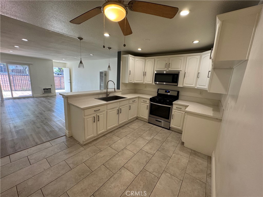 3100 Garnet Lane Fullerton, CA 92831 - Photo 10 of 14 a kitchen with stainless steel appliances granite countertop a stove a sink and a refrigerator