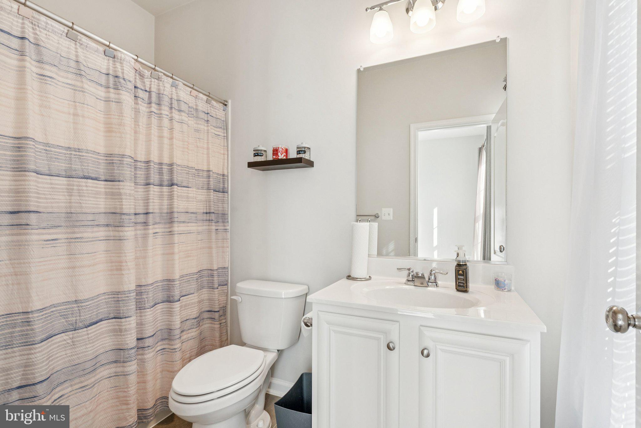 2616 Hardaway Circle Hanover, MD 21076 - Photo 12 of 21 a bathroom with a sink a toilet and shower curtain