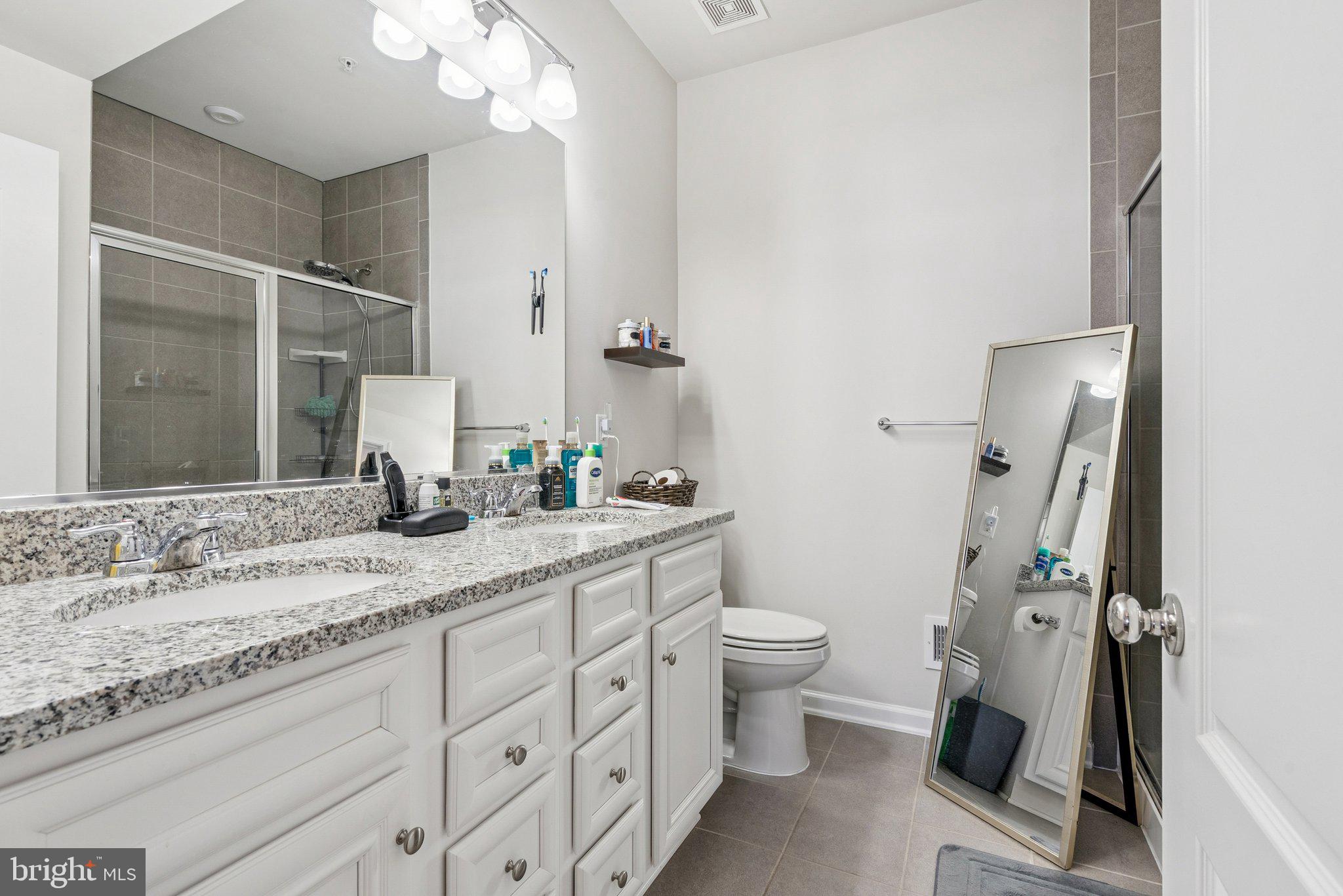 2616 Hardaway Circle Hanover, MD 21076 - Photo 16 of 21 a bathroom with a granite countertop sink toilet and shower