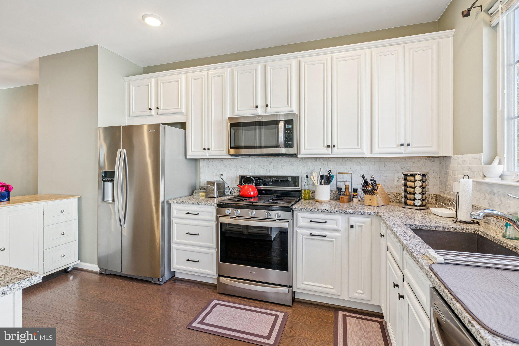 2616 Hardaway Circle Hanover, MD 21076 - Photo 4 of 21 a kitchen with white cabinets and stainless steel appliances