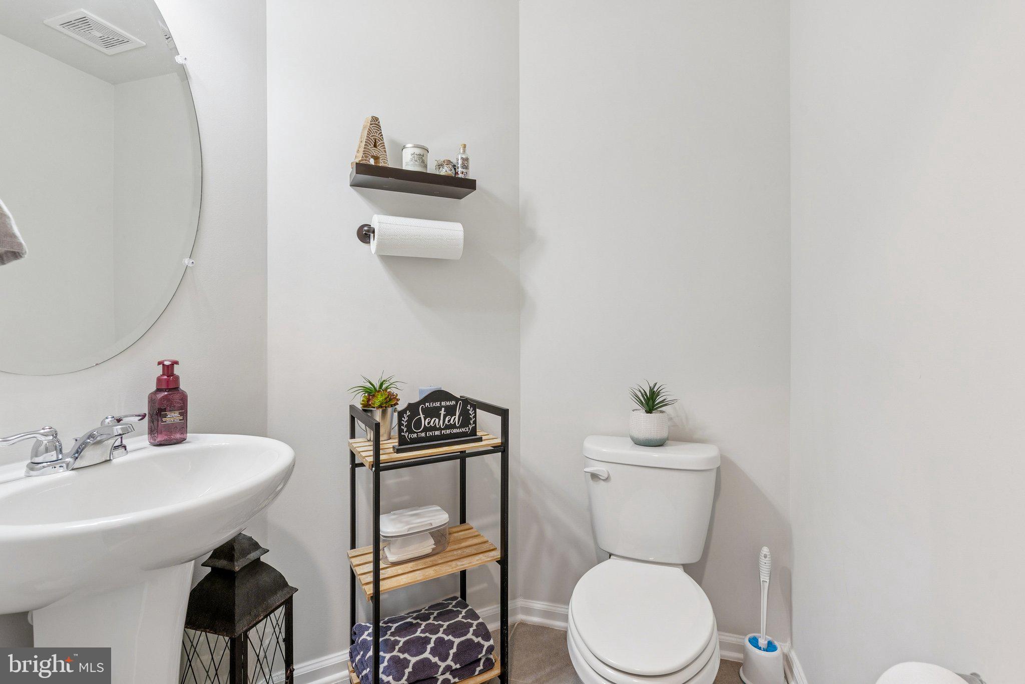 2616 Hardaway Circle Hanover, MD 21076 - Photo 9 of 21 a bathroom with a toilet a sink and a mirror