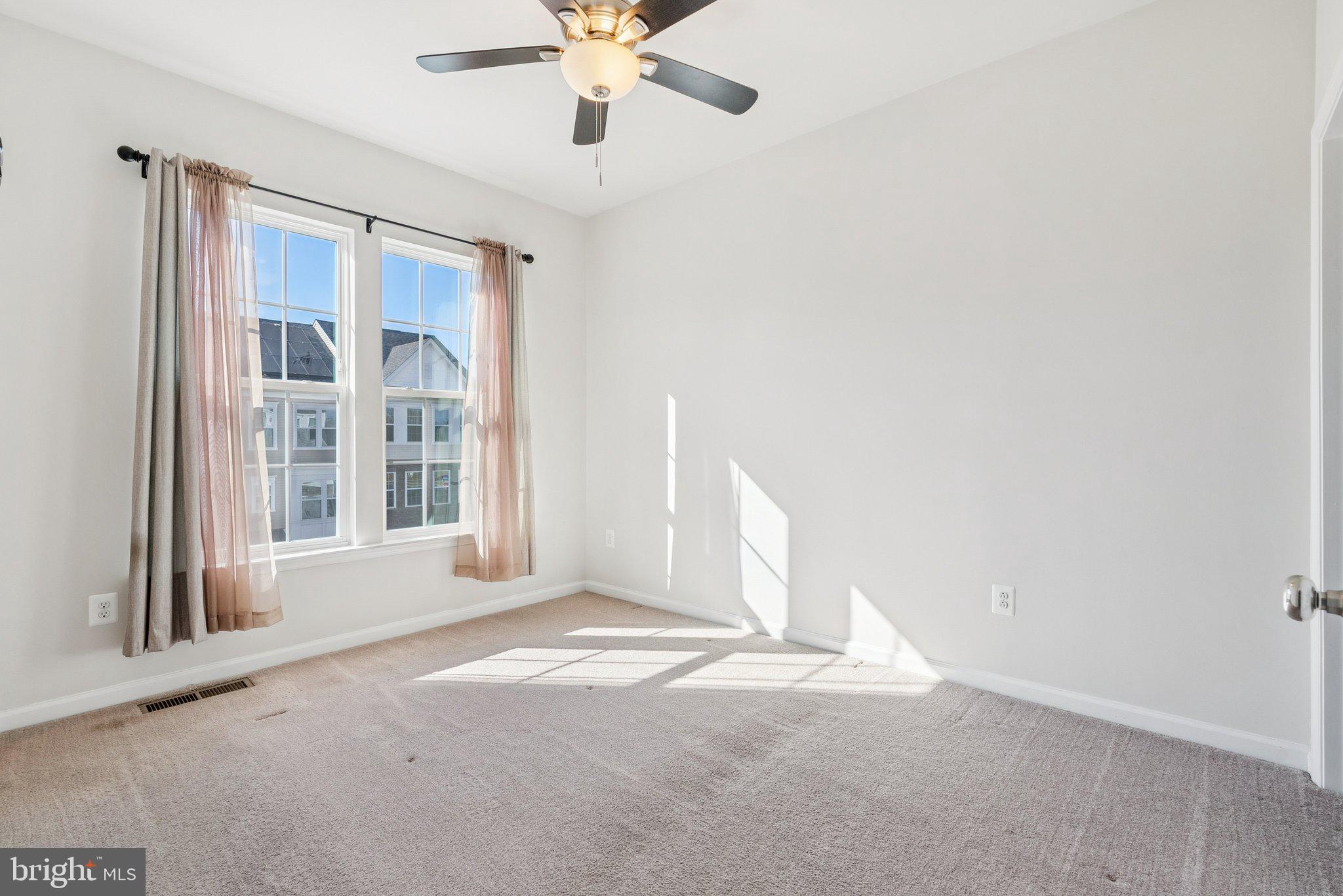 2616 Hardaway Circle Hanover, MD 21076 - Photo 10 of 21 en empty room with windows and ceiling fan