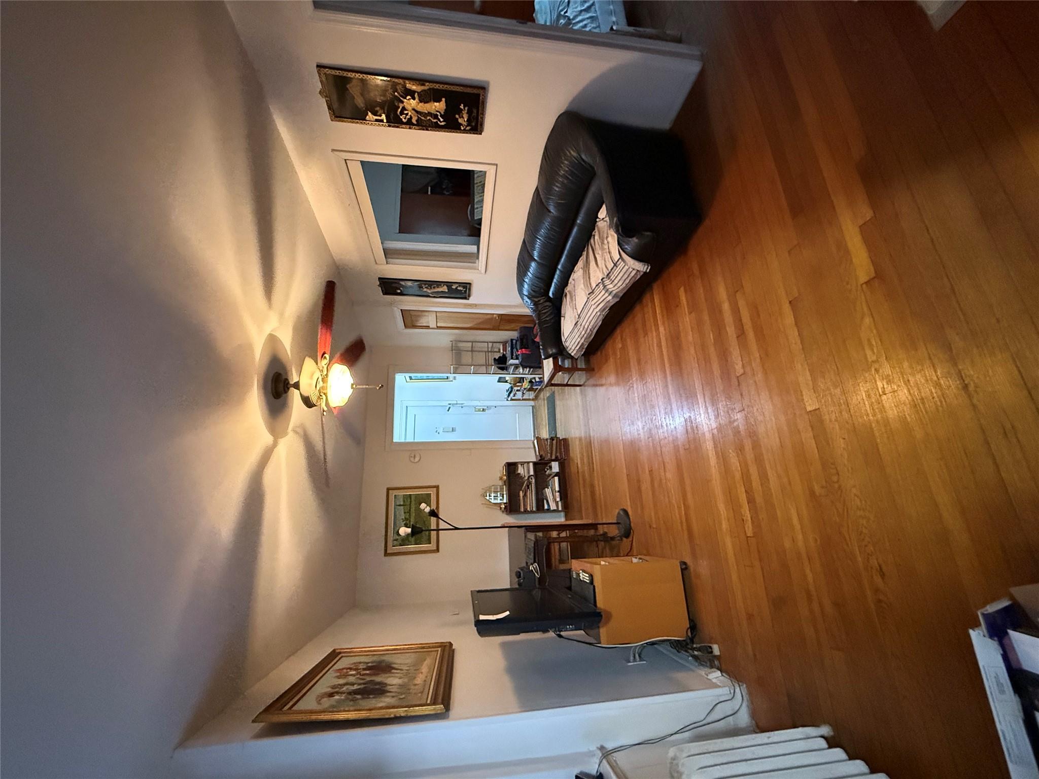 42-04 Layton Street, Unit 311 Queens, NY 11373 - Photo 3 of 4 Living room with hardwood / wood-style flooring, radiator heating unit, and ceiling fan