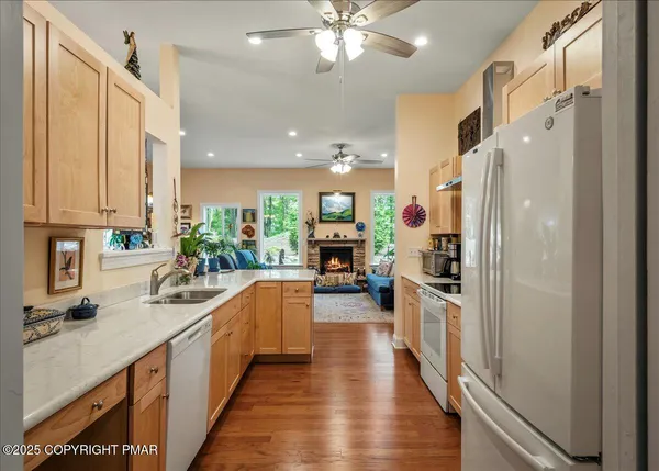 a kitchen with wooden floor and stainless steel appliances