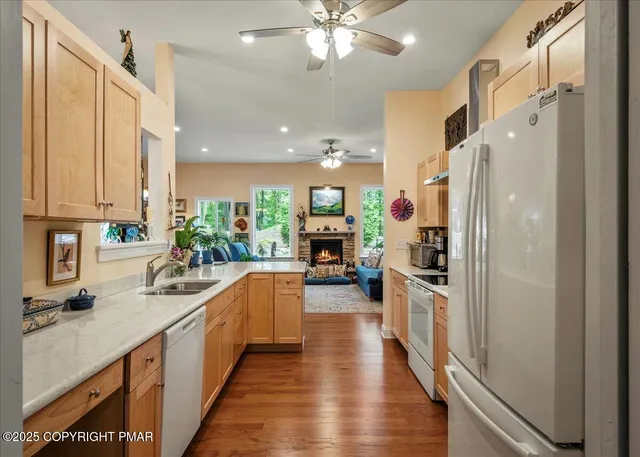 a kitchen with wooden floor and stainless steel appliances