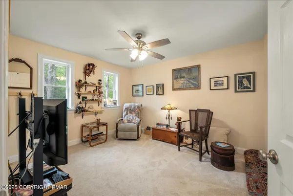 a view of a workspace with furniture and a window