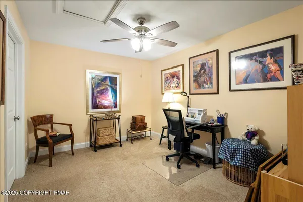 a work room with furniture and ceiling fan