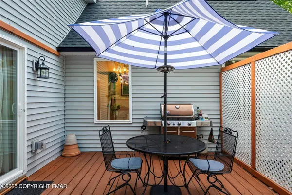 a backyard of a house with wooden seating