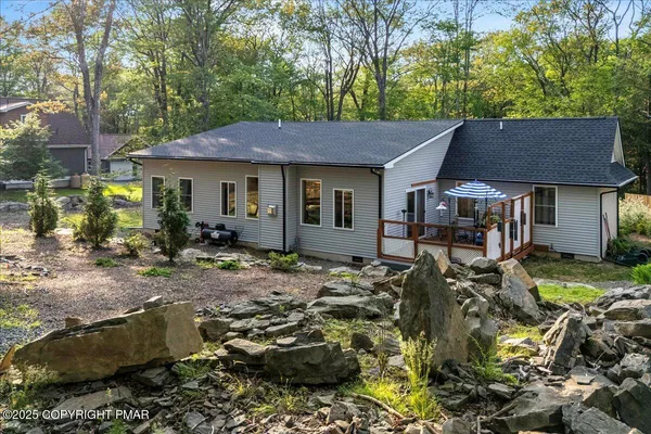 a backyard of a house with table and chairs
