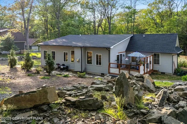 a backyard of a house with table and chairs