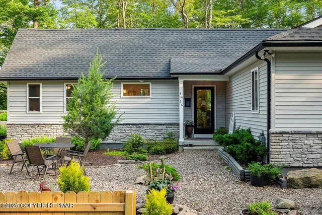 a front view of a house with garden