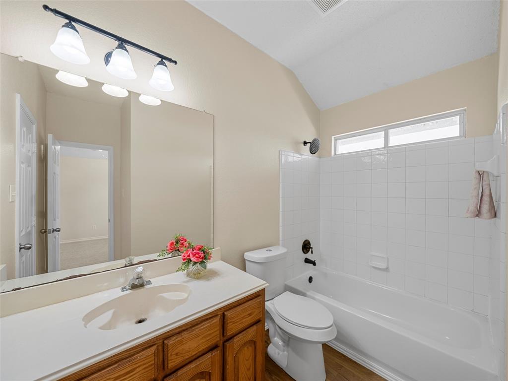 741 Aspen Court Allen, TX 75002 - Photo 36 of 40 Full bath with vanity, shower combination, lofted ceiling, and wood finished floors