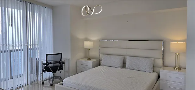 a bedroom with a bed and a chair