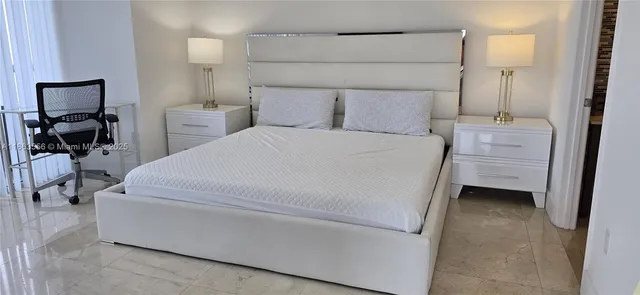 a bedroom with a bed and a table