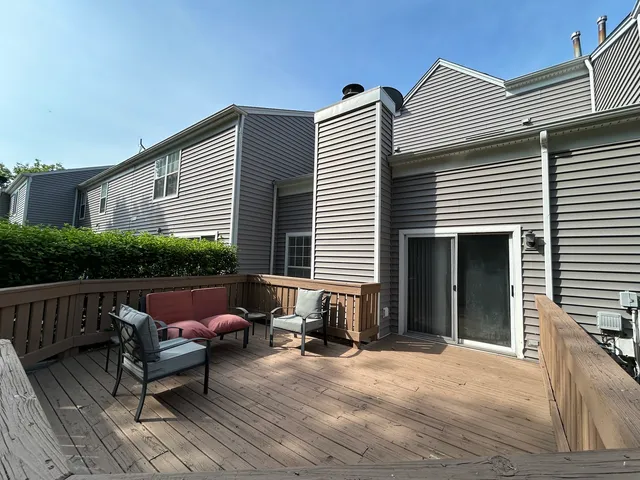 a balcony with furniture and potted plants
