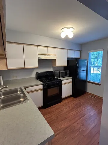 a kitchen with a sink stove and refrigerator